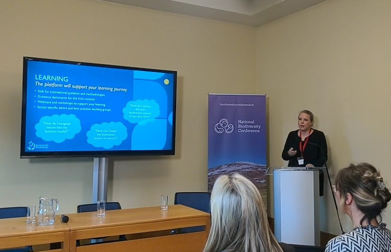 Woman speaking at a podium.