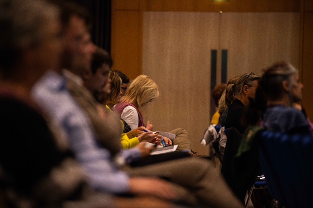 Person taking notes at a conference.