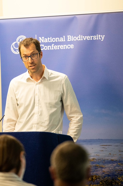 Person taking notes at a conference.