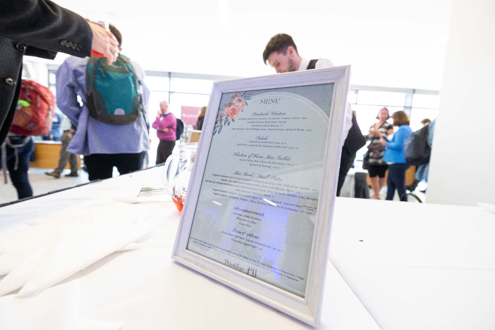 Framed menu placed on a dining table.
